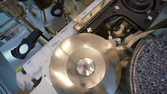 pharmaceutical industry - vaccine drug glass vial ampoules in a medicine factory creative view of small vials collected for manufacturing small glass injection moving in a pharma equipment machinery