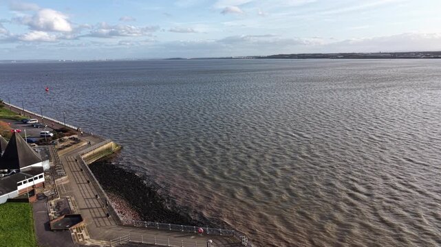 4K aerial video showing the River Mersey near Birkenhead Merseyside with calm open water and soft daylight across the surface.