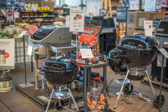 Close up view of Weber charcoal grills and briquettes display in modern store interior. Sweden. 