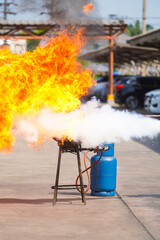 Employees firefighting training, Concept Employees hand using fire extinguisher fighting fire...
