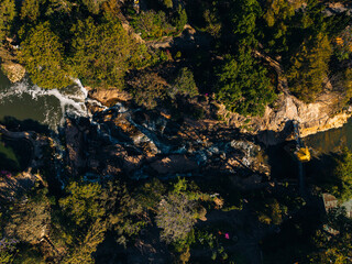 Naklejka premium River rapids flowing through rocky forested canyon from above Da Lat Vietnam