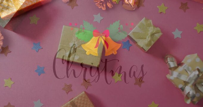 Animation of christmas greetings text over christmas presents and decorations