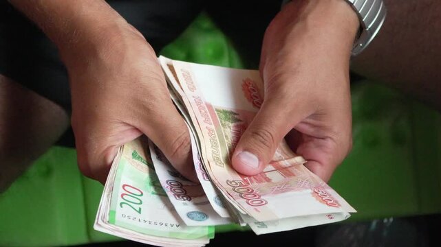 Money counting hands, person counting Russian rubles for financial transactions