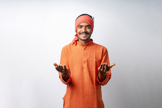 Indian farmer in traditional wear open palm while standing on wh