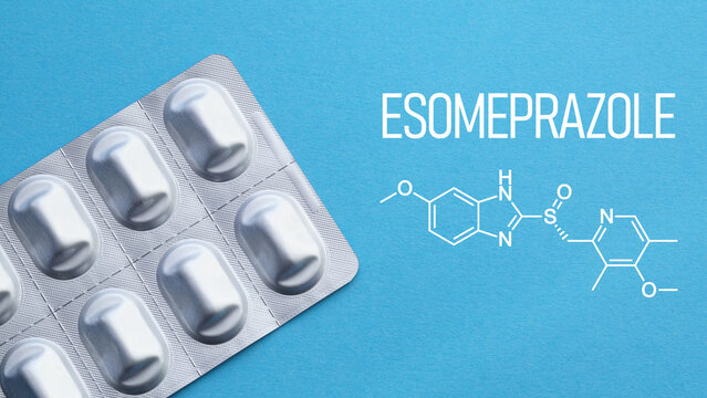 Esomeprazole medication concept with capsules and stomach care theme, proton pump inhibitor for acid reflux treatment, heartburn relief and gastrointestinal therapy