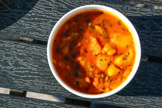 Indian cuisine Spicy potato curry (aloo bhaji), a traditional dish from North India. This flavorful curry is made with boiled potatoes cooked in aromatic spices like turmeric, mustard seeds, and curry