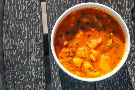 Indian cuisine Spicy potato curry (aloo bhaji), a traditional dish from North India. This flavorful curry is made with boiled potatoes cooked in aromatic spices like turmeric, mustard seeds, and curry