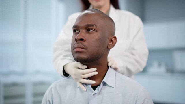 Doctor Carefully Palpates A Patient's Neck During Physical Exam, Checking