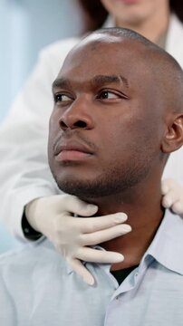 Doctor Carefully Palpates A Patient's Neck During Physical Exam, Checking