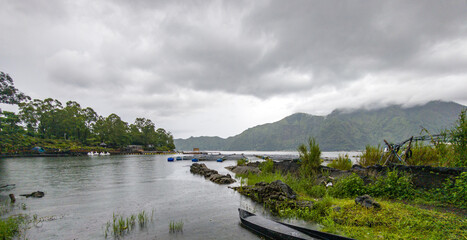 Fototapeta premium Overcast sky hangs low above calm waters