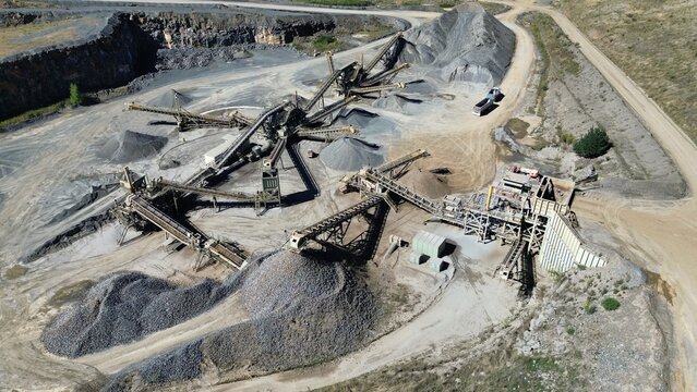 Aerial drone view of quarry with conveyor belts and gravel processing plant