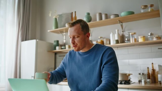 Freelancer drinking coffee videocall sitting modern kitchen table closeup. 