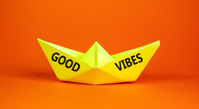 Good vibes words symbol. Concept words Good vibes on beautiful yellow paper boat. Beautiful orange background. Business lifestyle and Good vibes words concept. Copy space.