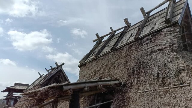 Ancient Japanese Pit Dwelling House from Jomon or Yayoi Period Under Cloudy Sky