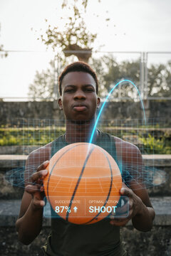 Young basketball player holding ball while analyzing shot trajectory with digital overlay