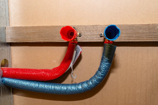 Insulated red and blue pex water pipes plumbing installation