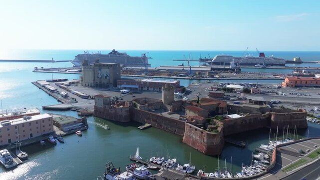 old meets new, old fortress of Livorno Italy, modern port with commercial shipping and tourism
