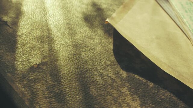 A slow pan over a handwritten letter resting on a textured archive folder in warm, ambient light. Includes copy space for text overlays.