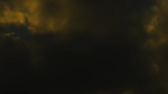 Moody and atmospheric footage of dark rain clouds. High contrast between the dark silhouettes and orange light. Great for foreshadowing or weather-related projects.