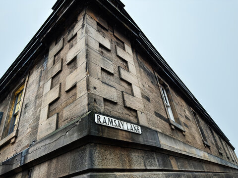 Ramsay Lane street corner in Edinburgh, Scotland UK showcasing historic sandstone building architecture and textured facade from a dramatic low angle