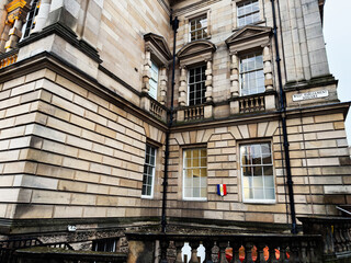 Naklejka premium Historic sandstone civic Parliament House building at West Parliament Square in Edinburgh, Scotland UK showcasing classical architecture, balustrades, tall windows and ornate stone facade