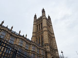 Naklejka premium Gothic Revival Palace of Westminster tower in London, UK, historic Parliament building and landmark