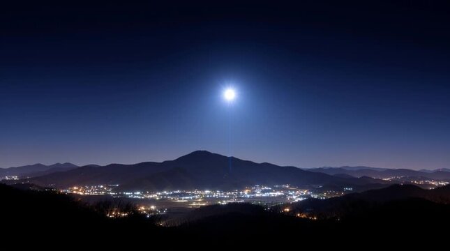 Luminous munition with a light beam over a glowing mountain valley town at night. Unidentified flying object. Air defence. Antiaircraft defense. Anti aircraft