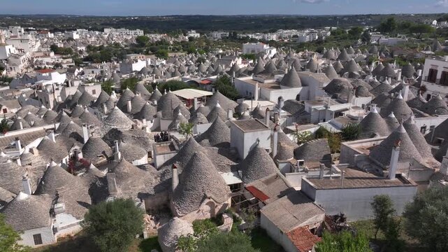 Traditional Trulli Rooftops, Aerial Shot of Unique Conical Roofed Houses of Alberobello in Puglia, Italy. Sunny Day.