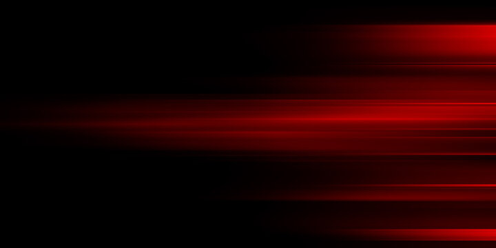 The effect of red light in fast motion on a black background. blurred abstract background with long exposure. neon light

