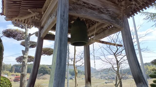 Japanese temple bell in traditional Buddhist temple, peaceful rural landscape in Japan