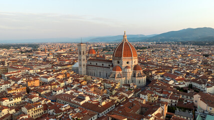 Drone shot Florence Italy summer sunrise city landscape. Santa Maria del Fiore cathedral dome aerial view. Scenic historic landmark Tuscany travel photography renaissance beauty background. © marina_larina