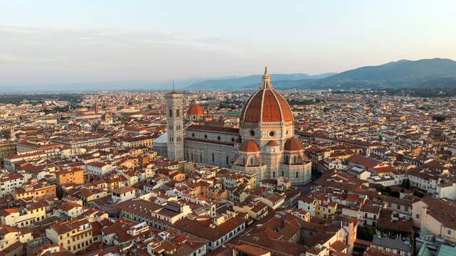 Drone shot Florence Italy summer sunrise city landscape. Santa Maria del Fiore cathedral dome aerial view. Scenic historic landmark Tuscany travel photography renaissance beauty background.