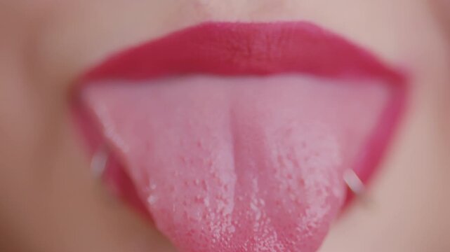 Woman with pierced tongue sticking out