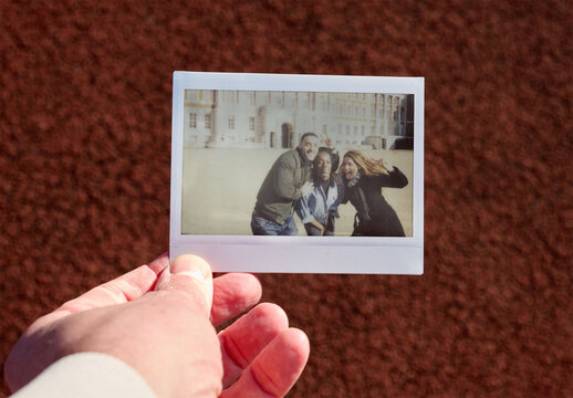 Real photo of Polaroid Held Outdoors. PSD template mockup.