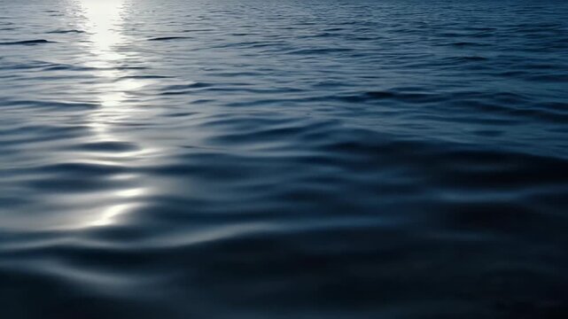Calm Blue Ocean With Gentle Waves Reflecting Bright Sunlight Creating Ripples of Light