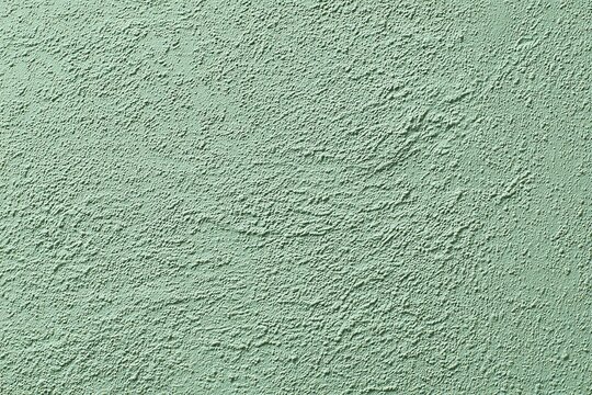 Pale sage microcement texture, minimalist seamless wall surface