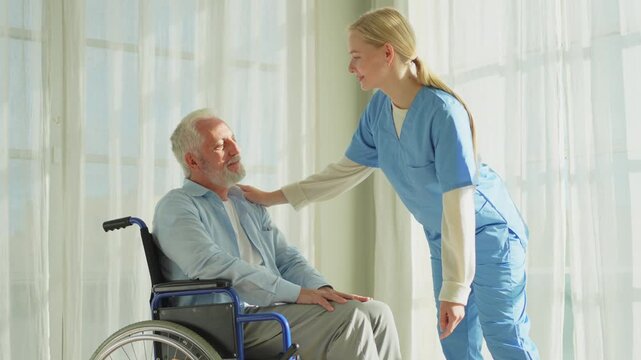 Help support retirement healthcare. Nurse helping old man in wheelchair. Patient and woman in nursing home for medical caregiver. Nurse taking care of paralyzed man in chair for people with disability