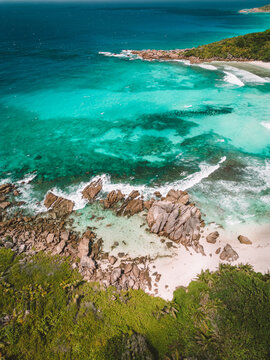 beach and rocks on anse coco in la digue, seychelles