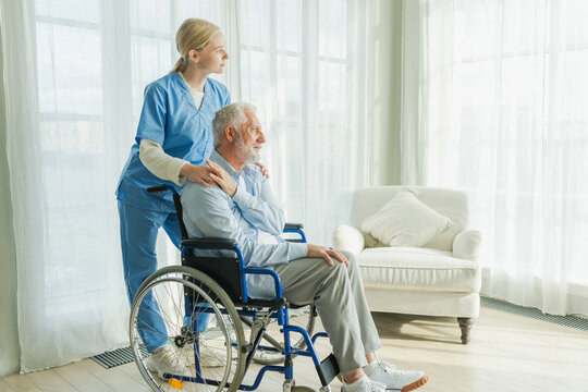 Help support retirement healthcare. Nurse helping old man in wheelchair. Patient and woman in nursing home for medical caregiver. Nurse taking care of paralyzed man in chair for people with disability