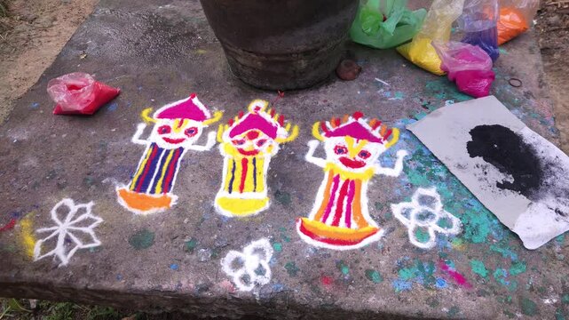 Close up of woman hand drawing colorful rangoli with powder on ground, traditional Indian floor art with vibrant patterns, Odia cultural decoration for festivals, showing creativity