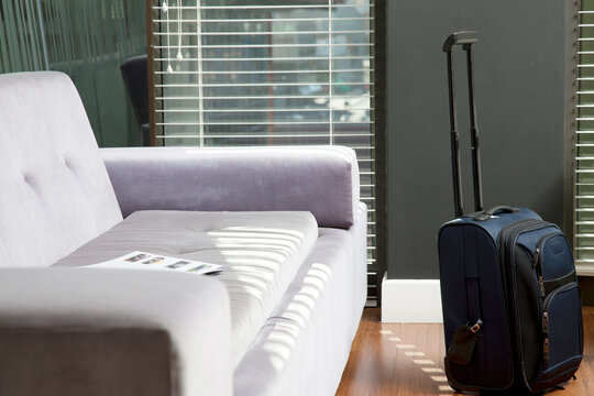 Carry on luggage next to a sofa in an office