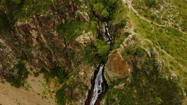 Aerial cinematic tilt-up of Medvezhiy waterfall in Turgen Gorge, Kazakhstan 4K ProRes