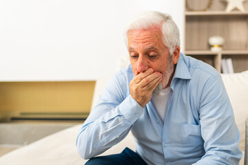 Fototapeta premium Healthcare medicine. Senior man with high fever symptoms illness cold seasonal influenza covering mouth with his hand coughing. Elderly man with seasonal infections flu suffering from disease pain
