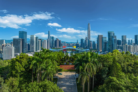 Shenzhen Futian CBD skyline and civic center axis with modern skyscrapers, lush park foreground and blue sky, symbol of China urban growth