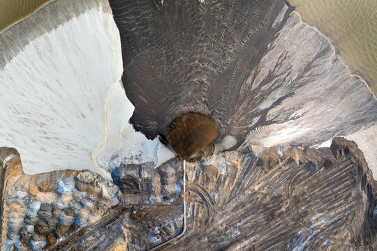Active phosphate mine in Florida with slurry pipeline transporting water, clay and sand from dredging pit.