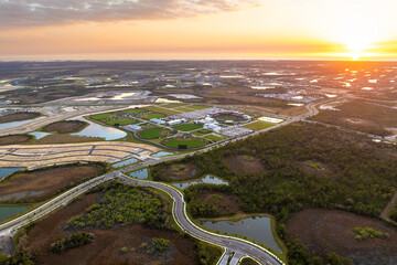 Fototapeta premium Beginning of construction works on prepared ground. Large building site in American rural area. Development of residential housing in US suburbs. Real estate market in USA