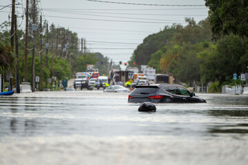 Hurricane Debby flooded city street with trapped cars submerged under water in Florida residential...