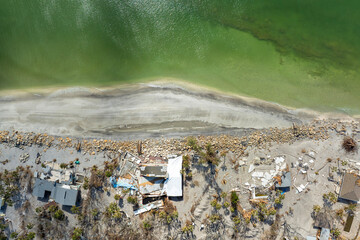 Natural disaster and its consequences. Hurricane destroyed houses roof and walls in Florida coastal...