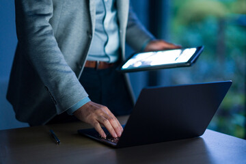 Business professional using laptop and tablet for work at desk © zhu difeng