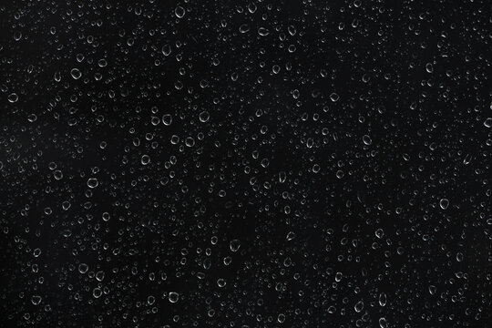 Raindrops on glass window isolated on transparent background. High-contrast water droplet texture for cinematic overlays, stormy weather effects, and atmospheric digital art backgrounds